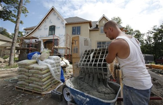 Andrew VanDusen mixes cement for a new home under construction in Clarence, N.Y. Construction of new U.S. homes surged 10.5 percent in August, the Commerce Department said.